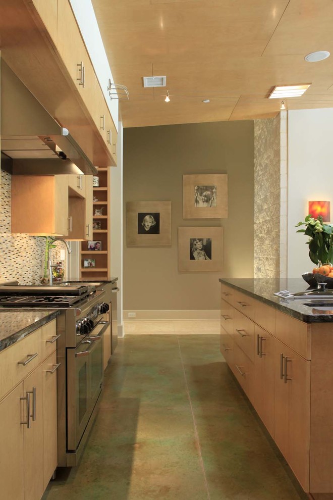 Example of a large minimalist l-shaped concrete floor eat-in kitchen design in Houston with a farmhouse sink, flat-panel cabinets, light wood cabinets, granite countertops, multicolored backsplash, matchstick tile backsplash, stainless steel appliances and an island