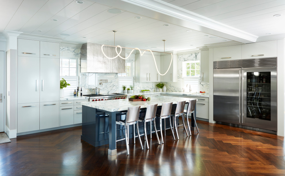 Trendy medium tone wood floor, brown floor and coffered ceiling eat-in kitchen photo in New York with an undermount sink, white cabinets, marble countertops, white backsplash, marble backsplash, stainless steel appliances, an island, yellow countertops and flat-panel cabinets