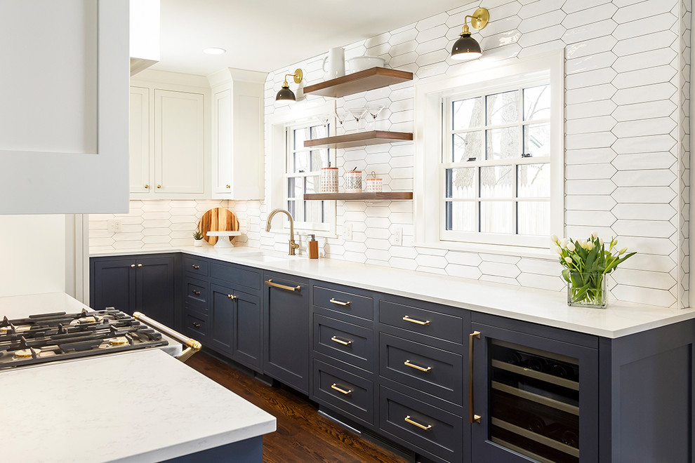 Inspiration for a mid-sized transitional dark wood floor and brown floor kitchen remodel in Minneapolis with shaker cabinets, blue cabinets, quartz countertops, white backsplash, ceramic backsplash, paneled appliances, a single-bowl sink and white countertops