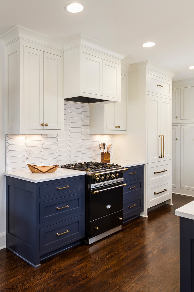 Medium sized classic l-shaped kitchen/diner in Minneapolis with a submerged sink, shaker cabinets, white cabinets, engineered stone countertops, white splashback, ceramic splashback, integrated appliances, dark hardwood flooring, no island and brown floors.