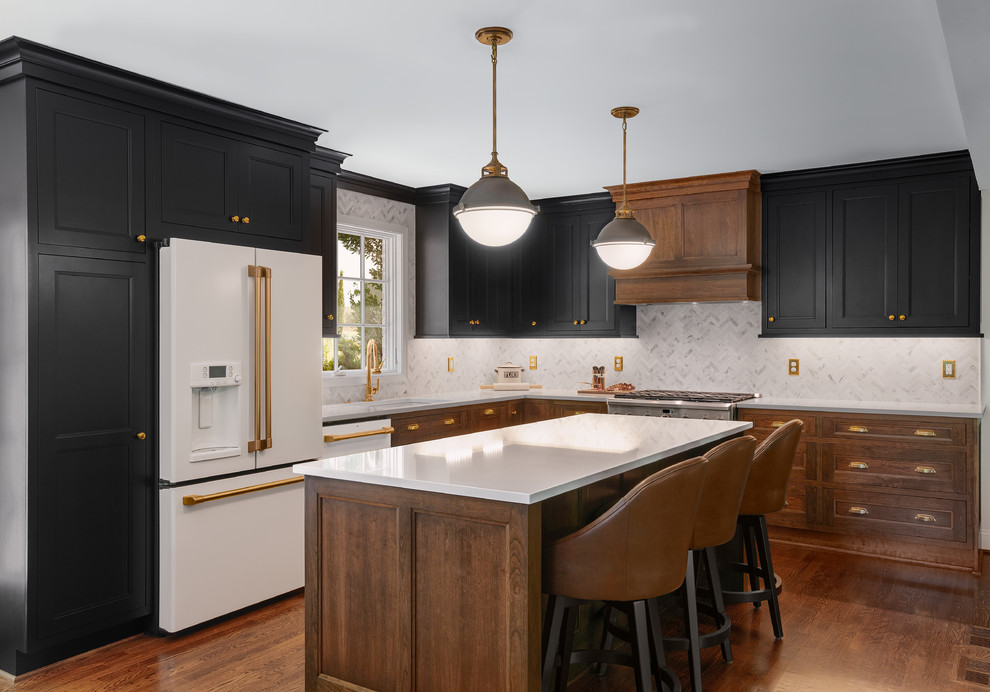 Eat-in kitchen - large contemporary l-shaped dark wood floor and brown floor eat-in kitchen idea in DC Metro with an island, an undermount sink, shaker cabinets, black cabinets, solid surface countertops, white backsplash, marble backsplash, white appliances and white countertops