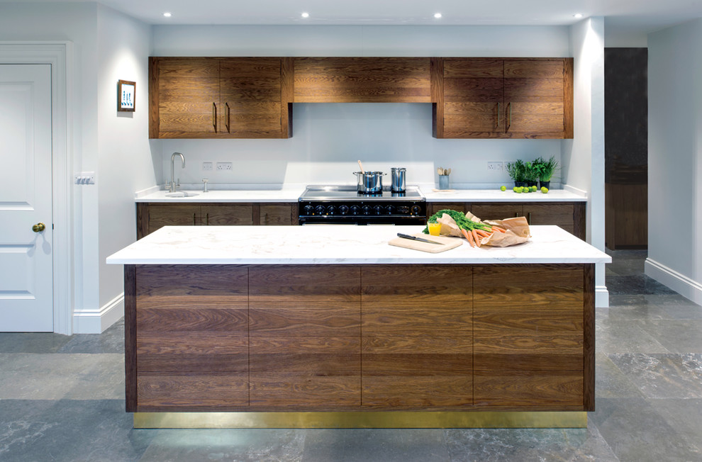 Inspiration for an expansive contemporary open plan kitchen in Sussex with a submerged sink, flat-panel cabinets, dark wood cabinets, marble worktops, white splashback, marble splashback, integrated appliances, ceramic flooring, multiple islands and grey floors.