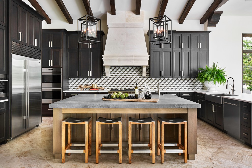 Inspiration for a mediterranean beige floor kitchen remodel in Austin with a farmhouse sink, shaker cabinets, dark wood cabinets, multicolored backsplash, stainless steel appliances, an island and white countertops