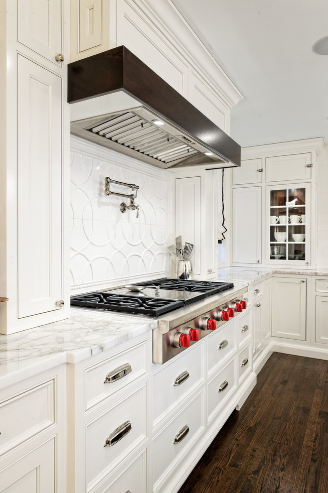 Large transitional u-shaped dark wood floor eat-in kitchen photo in Cleveland with an undermount sink, beaded inset cabinets, white cabinets, marble countertops, white backsplash, ceramic backsplash, paneled appliances and two islands