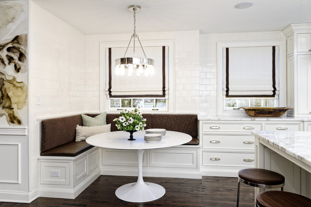 Inspiration for a traditional u-shaped kitchen/diner in Cleveland with a submerged sink, beaded cabinets, white cabinets, marble worktops, white splashback, ceramic splashback, integrated appliances, dark hardwood flooring and multiple islands.
