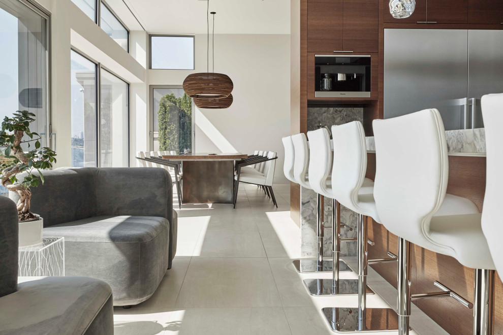 Eat-in kitchen - large modern u-shaped porcelain tile and white floor eat-in kitchen idea in Seattle with an undermount sink, flat-panel cabinets, dark wood cabinets, marble countertops, gray backsplash, stone slab backsplash, stainless steel appliances, an island and gray countertops