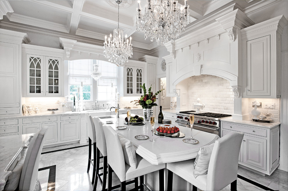 Eat-in kitchen - large traditional u-shaped marble floor eat-in kitchen idea in New York with a farmhouse sink, white cabinets, quartzite countertops, paneled appliances, beaded inset cabinets, white backsplash, subway tile backsplash and an island