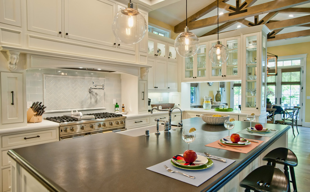 Inspiration for a timeless eat-in kitchen remodel in Los Angeles with a farmhouse sink, glass-front cabinets, white cabinets, white backsplash and subway tile backsplash