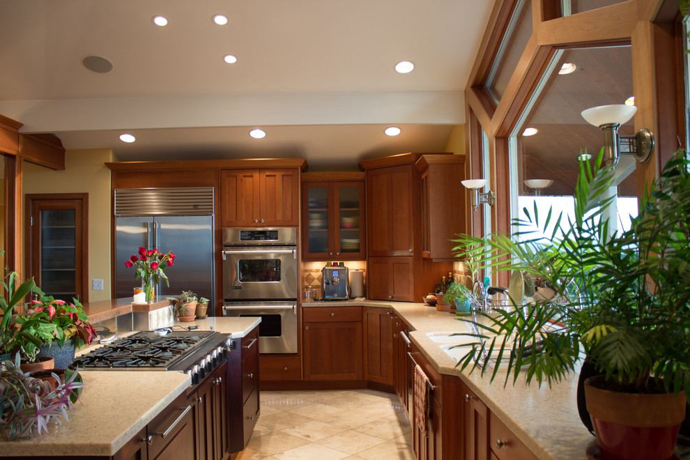 Eat-in kitchen - large craftsman single-wall marble floor eat-in kitchen idea in Salt Lake City with a double-bowl sink, recessed-panel cabinets, medium tone wood cabinets, granite countertops, beige backsplash, ceramic backsplash, stainless steel appliances and an island