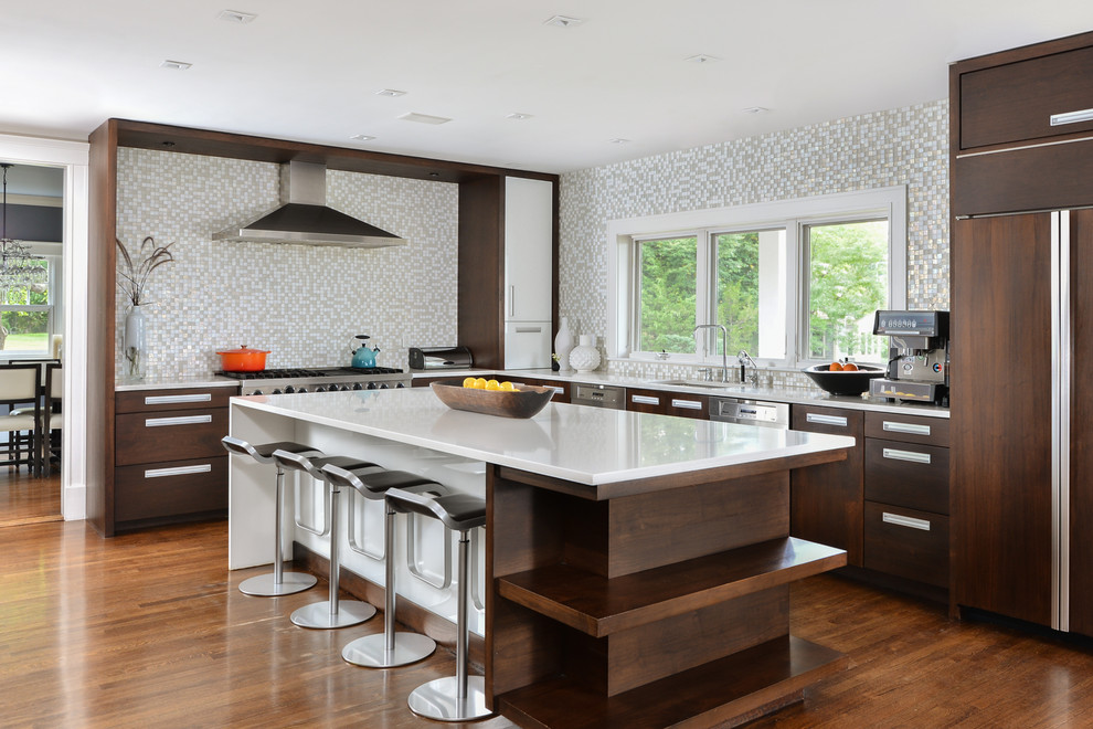 Photo of a large contemporary u-shaped kitchen/diner in Boston with a submerged sink, flat-panel cabinets, dark wood cabinets, marble worktops, white splashback, mosaic tiled splashback, stainless steel appliances, medium hardwood flooring and an island.