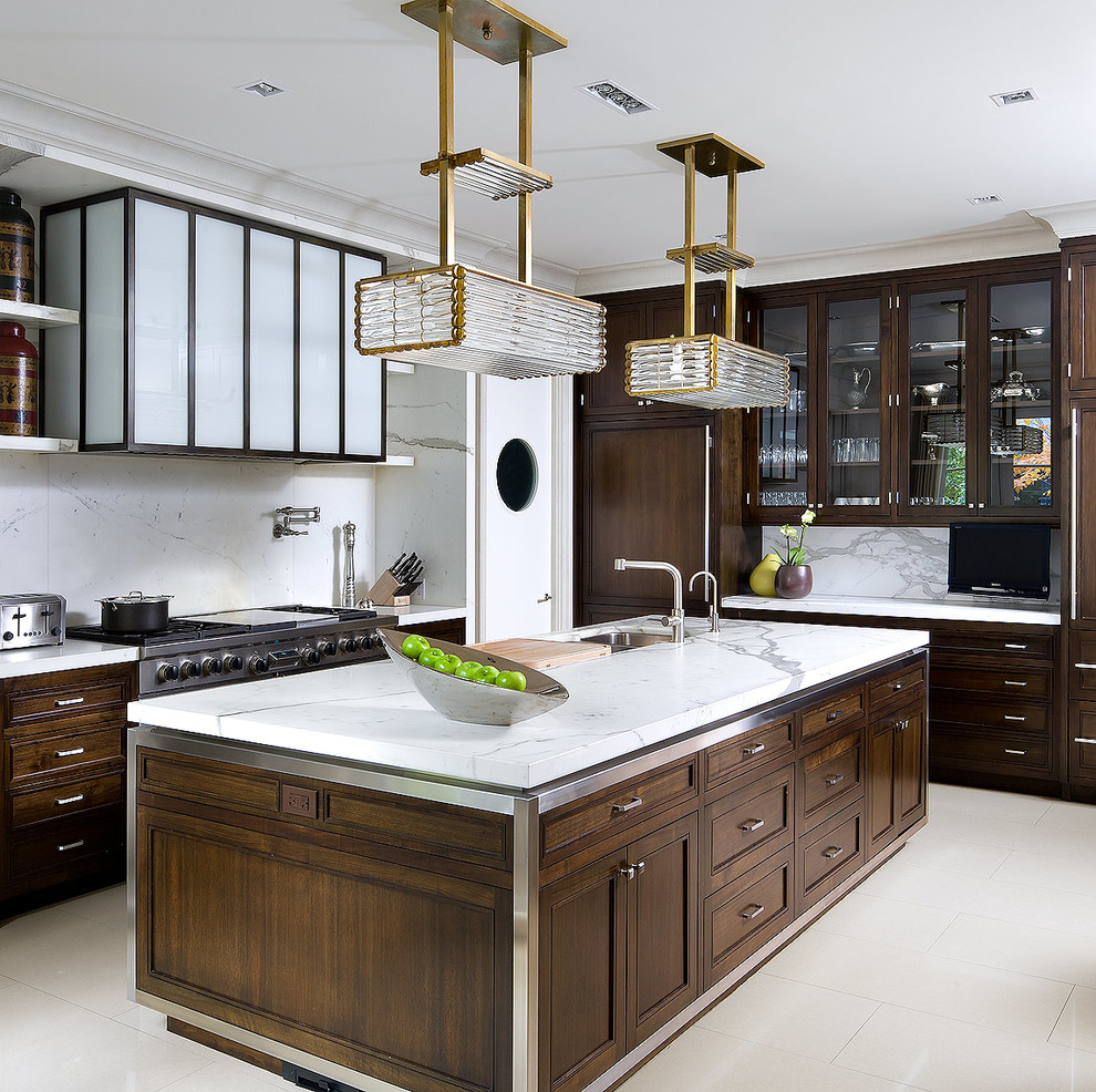 This is an example of a contemporary l-shaped kitchen in Toronto with a submerged sink, recessed-panel cabinets, dark wood cabinets, white splashback, stainless steel appliances and marble splashback.