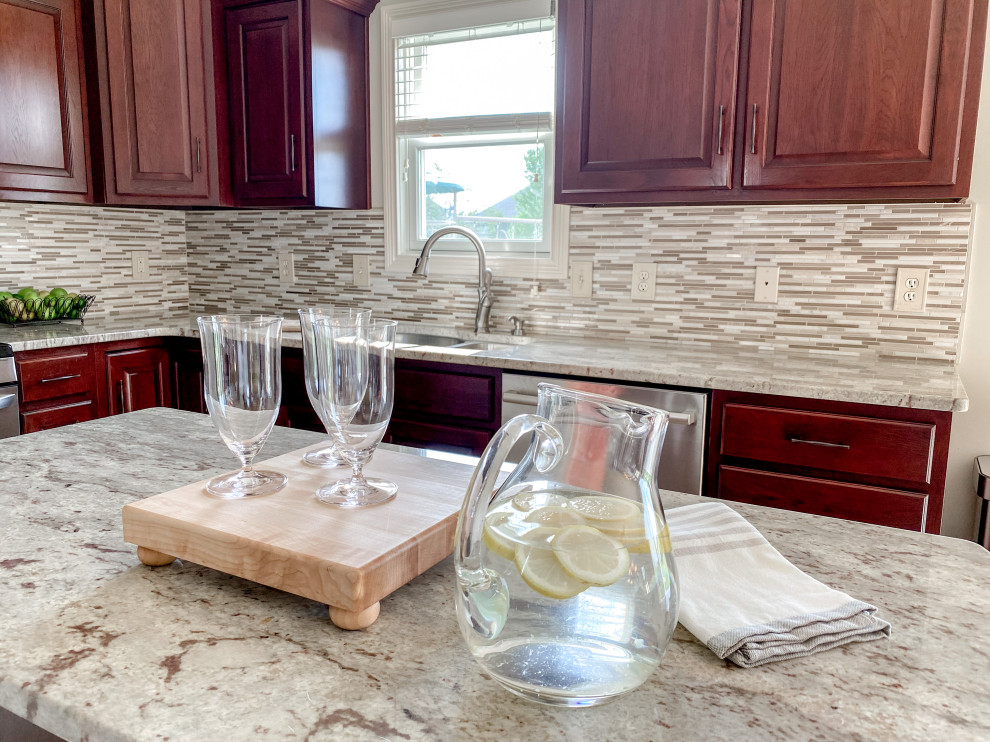 Inspiration for a transitional kitchen remodel in Other with an undermount sink, granite countertops, white backsplash, ceramic backsplash and an island