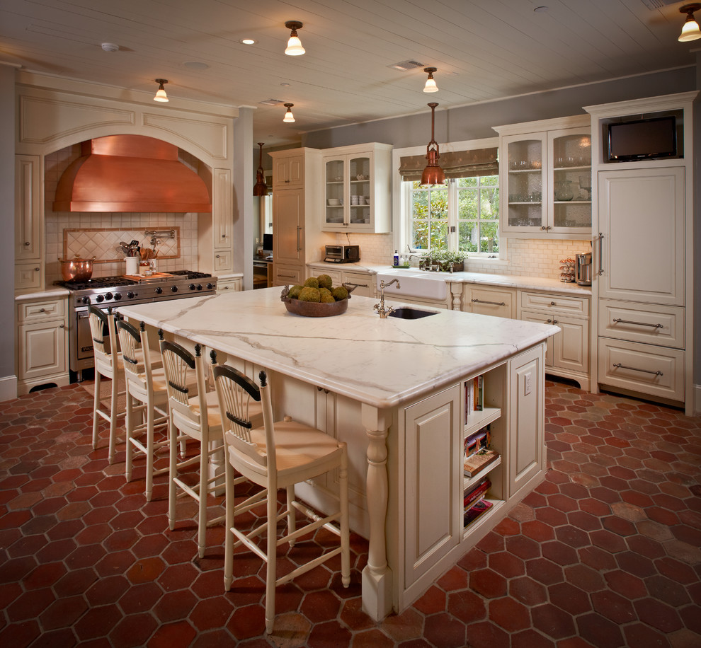 Inspiration for a timeless kitchen remodel in Houston with a farmhouse sink, glass-front cabinets, beige cabinets, white backsplash, subway tile backsplash and paneled appliances