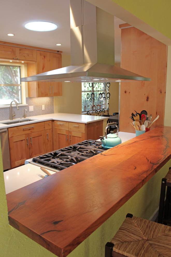 Inspiration for a mid-sized transitional galley medium tone wood floor enclosed kitchen remodel in Austin with an undermount sink, shaker cabinets, light wood cabinets, quartz countertops, gray backsplash, glass sheet backsplash, stainless steel appliances and no island