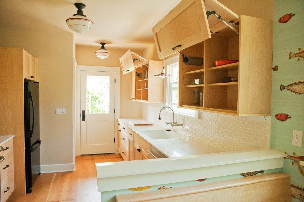 This is an example of a medium sized beach style galley kitchen/diner in Seattle with a submerged sink, flat-panel cabinets, light wood cabinets, engineered stone countertops, multi-coloured splashback, glass tiled splashback, stainless steel appliances, medium hardwood flooring and no island.