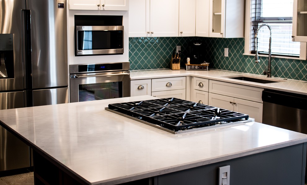 Example of a small transitional l-shaped porcelain tile and gray floor eat-in kitchen design in Boise with a single-bowl sink, shaker cabinets, white cabinets, quartz countertops, blue backsplash, glass tile backsplash, stainless steel appliances and an island