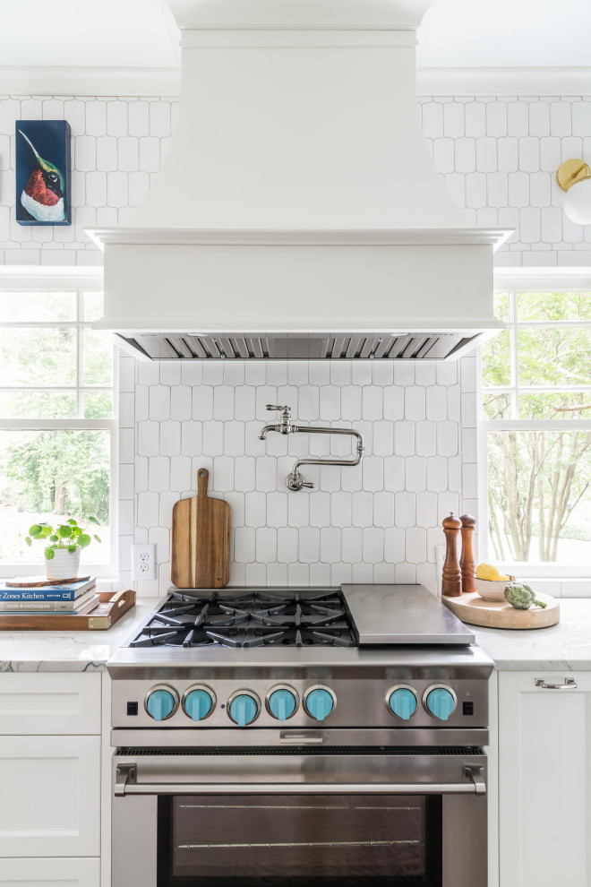Eat-in kitchen - large coastal galley dark wood floor and brown floor eat-in kitchen idea in Atlanta with an undermount sink, shaker cabinets, white cabinets, quartzite countertops, white backsplash, marble backsplash, paneled appliances, an island and white countertops