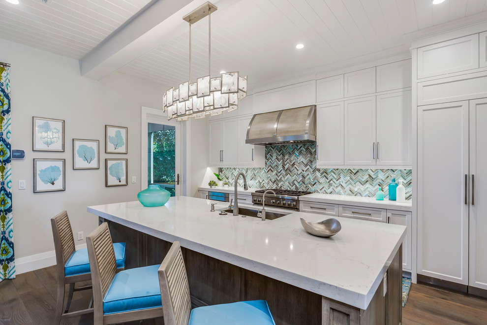 Island style dark wood floor kitchen photo in Miami with an undermount sink, shaker cabinets, white cabinets, multicolored backsplash, paneled appliances, an island and white countertops
