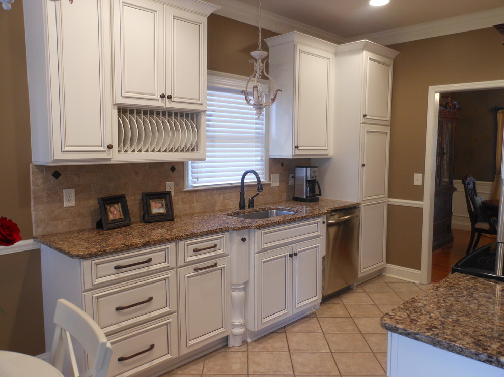 Example of a small classic galley ceramic tile eat-in kitchen design in Birmingham with a single-bowl sink, raised-panel cabinets, white cabinets, granite countertops, beige backsplash, stone tile backsplash, stainless steel appliances and no island