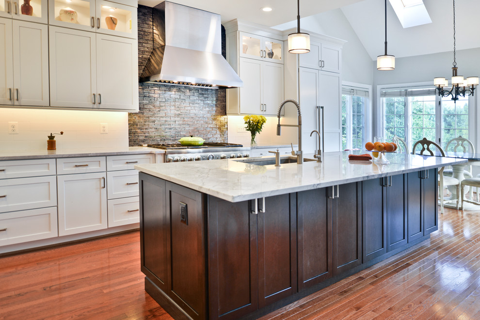 Example of a large minimalist light wood floor eat-in kitchen design in DC Metro with white cabinets, quartzite countertops, glass sheet backsplash, stainless steel appliances, an island and white countertops