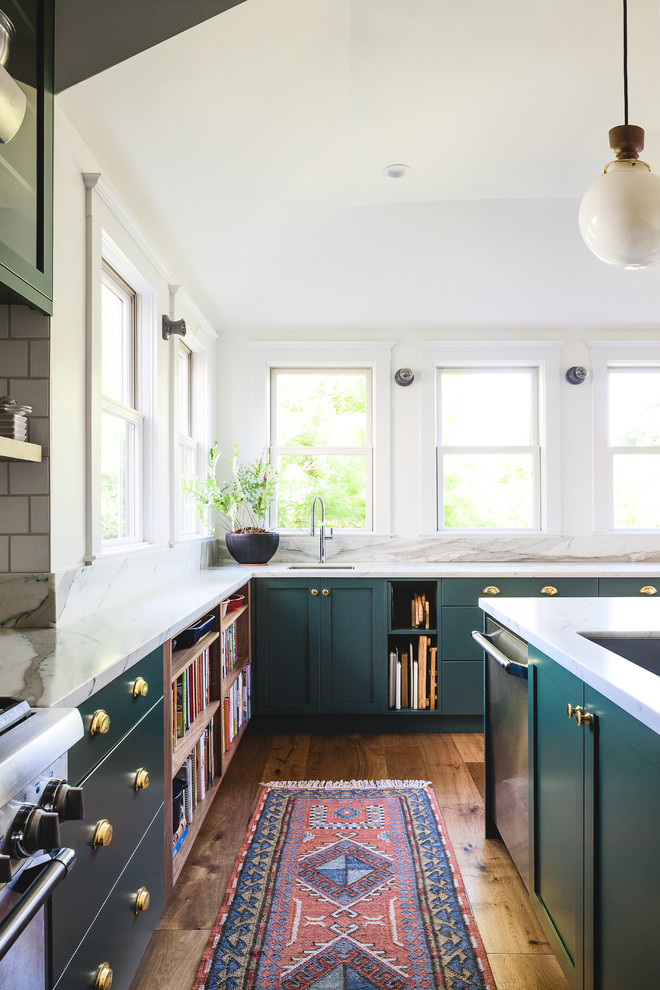 Enclosed kitchen - large transitional u-shaped dark wood floor enclosed kitchen idea in San Francisco with an undermount sink, shaker cabinets, green cabinets, marble countertops, white backsplash, ceramic backsplash, stainless steel appliances, an island and white countertops