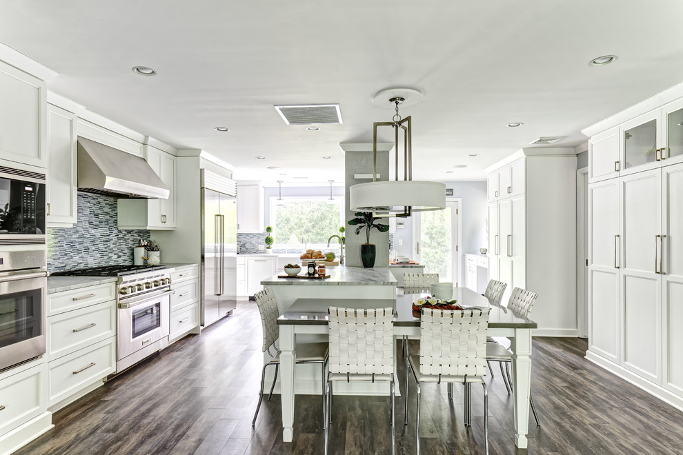 Inspiration for a large transitional l-shaped porcelain tile and brown floor open concept kitchen remodel in New York with a farmhouse sink, shaker cabinets, white cabinets, quartzite countertops, blue backsplash, mosaic tile backsplash, stainless steel appliances, an island and gray countertops