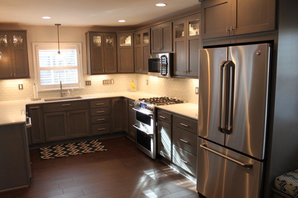 Inspiration for a timeless u-shaped eat-in kitchen remodel in Louisville with an undermount sink, flat-panel cabinets, gray cabinets, quartz countertops and stainless steel appliances