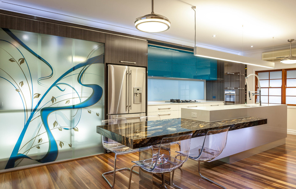 Zweizeilige, Mittelgroße Moderne Küche mit Küchengeräten aus Edelstahl, flächenbündigen Schrankfronten, Marmor-Arbeitsplatte, braunem Holzboden und Kücheninsel in Brisbane