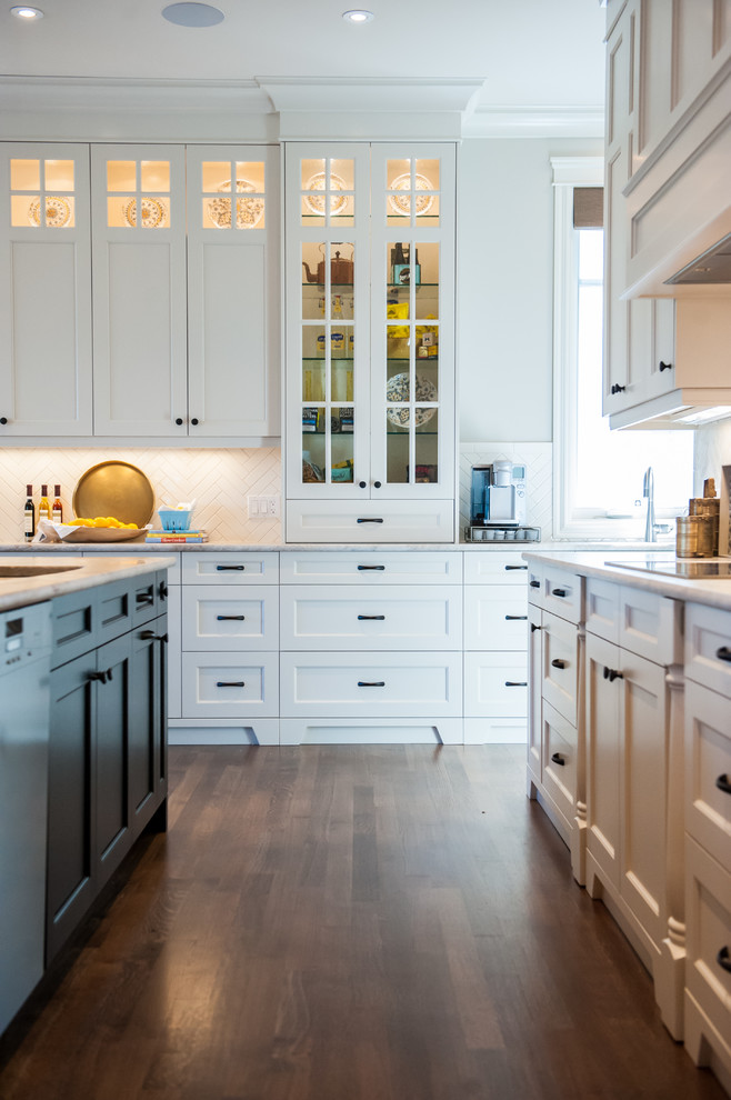 Large elegant l-shaped dark wood floor kitchen photo in Calgary with a double-bowl sink, shaker cabinets, white cabinets, white backsplash, ceramic backsplash and an island