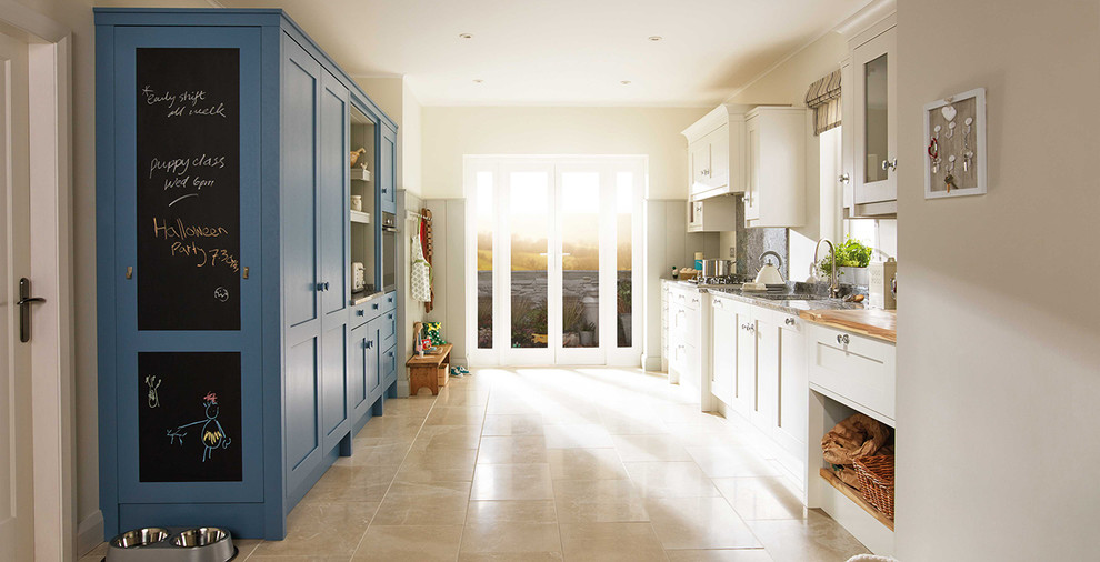 Photo of a medium sized farmhouse galley open plan kitchen in Dublin with a single-bowl sink, shaker cabinets, blue cabinets, granite worktops, integrated appliances, ceramic flooring and no island.