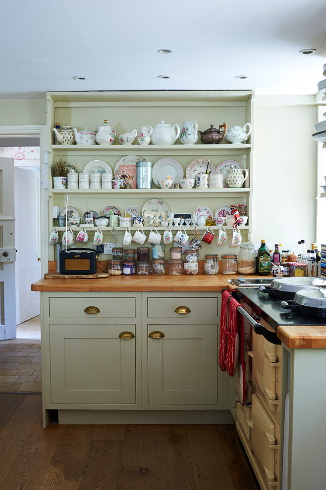Eat-in kitchen - small victorian l-shaped medium tone wood floor eat-in kitchen idea with shaker cabinets, green cabinets and wood countertops