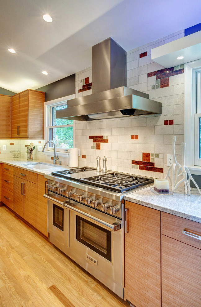 Large 1950s u-shaped light wood floor eat-in kitchen photo in Milwaukee with an undermount sink, flat-panel cabinets, light wood cabinets, granite countertops, white backsplash, stone tile backsplash, stainless steel appliances and no island