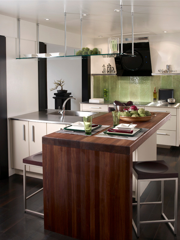 Eat-in kitchen - mid-sized contemporary l-shaped dark wood floor eat-in kitchen idea in Houston with a single-bowl sink, flat-panel cabinets, white cabinets, wood countertops, green backsplash, glass sheet backsplash, stainless steel appliances and an island