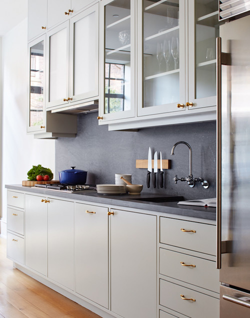 Choosing Hardware For Cabinets – modern white kitchen with brass knobs and pulls