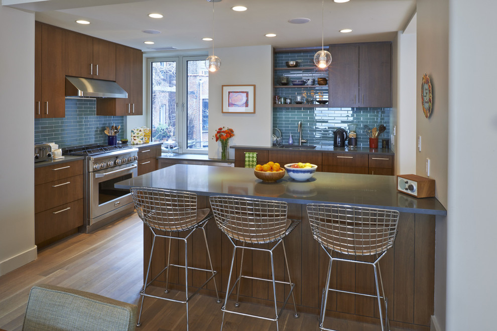 Eat-in kitchen - mid-sized contemporary u-shaped medium tone wood floor eat-in kitchen idea in New York with an undermount sink, flat-panel cabinets, medium tone wood cabinets, quartz countertops, green backsplash, glass tile backsplash, stainless steel appliances and a peninsula