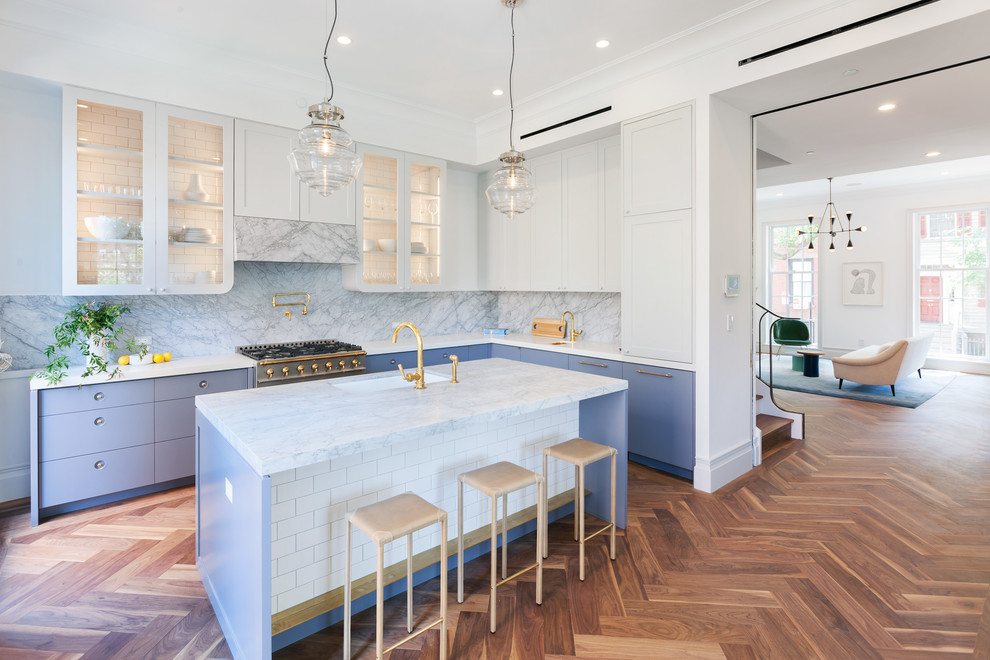 Kitchen - transitional l-shaped medium tone wood floor kitchen idea in New York with an undermount sink, glass-front cabinets, stone slab backsplash, stainless steel appliances and an island