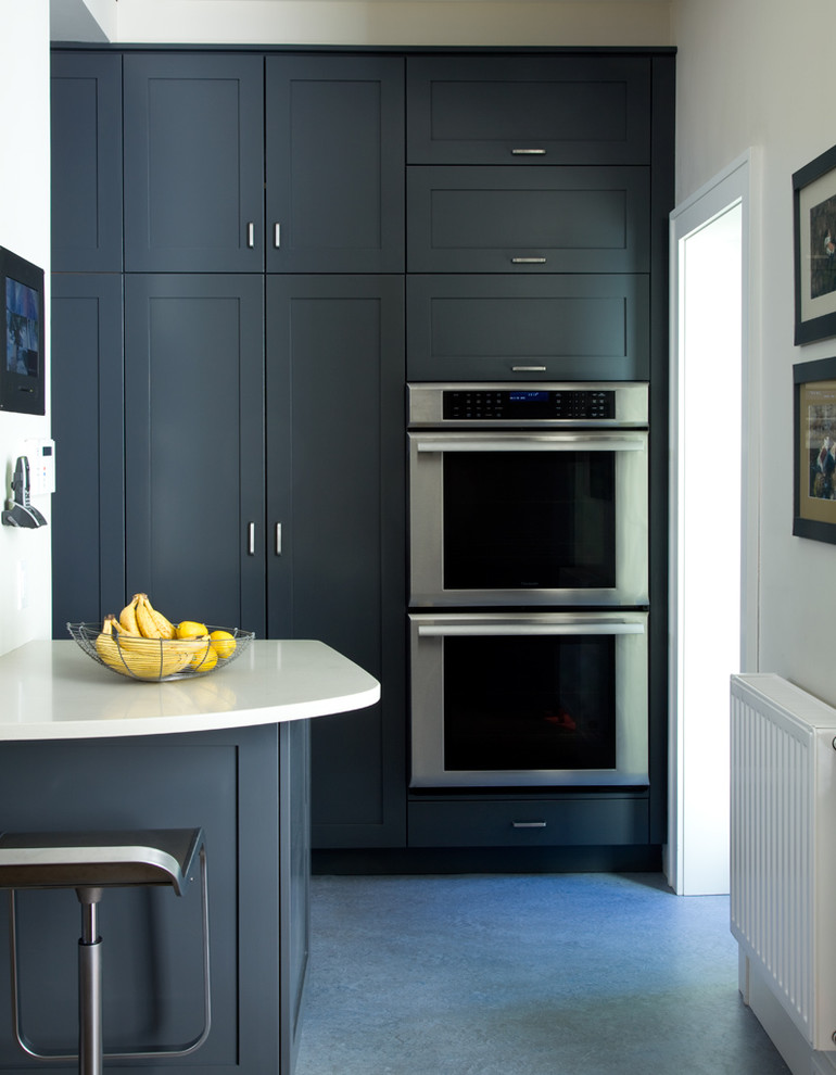 This is an example of a classic kitchen in New York with shaker cabinets, grey cabinets and stainless steel appliances.