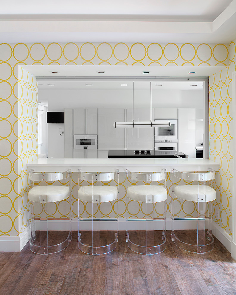 Mid-sized trendy galley ceramic tile eat-in kitchen photo in New York with flat-panel cabinets, white cabinets, white appliances and an island