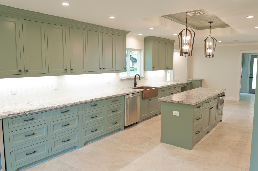 Large island style galley porcelain tile kitchen photo in Houston with a farmhouse sink, recessed-panel cabinets, green cabinets, granite countertops, white backsplash, glass tile backsplash, stainless steel appliances and an island
