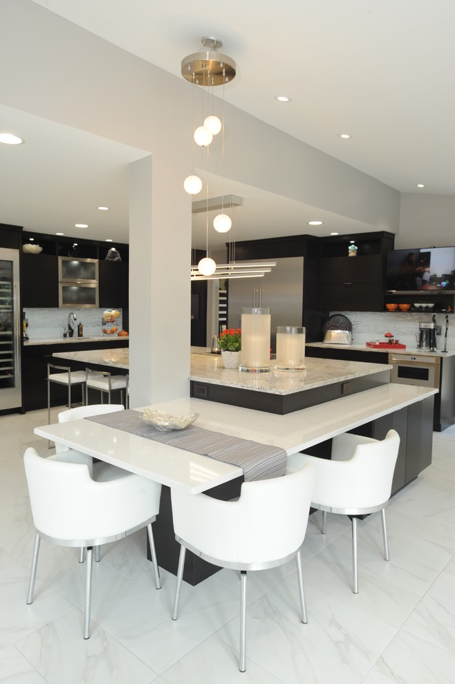 Expansive modern l-shaped kitchen/diner in Atlanta with a submerged sink, dark wood cabinets, engineered stone countertops, stainless steel appliances, porcelain flooring, an island, flat-panel cabinets, grey splashback, matchstick tiled splashback and white floors.