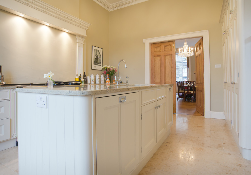 Photo of a large classic u-shaped open plan kitchen in Edinburgh with a submerged sink, shaker cabinets, white cabinets, granite worktops, integrated appliances, travertine flooring and an island.