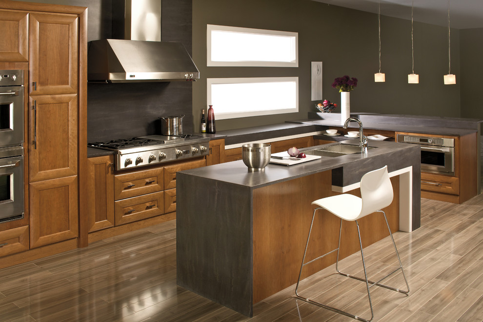 Design ideas for a modern l-shaped kitchen/diner in Salt Lake City with a submerged sink, recessed-panel cabinets, medium wood cabinets, engineered stone countertops, metallic splashback, metal splashback, stainless steel appliances, porcelain flooring and an island.