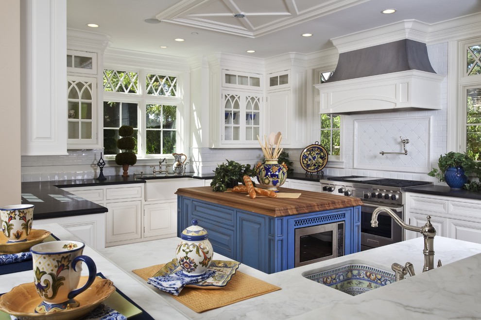Example of a classic kitchen design in San Francisco with stainless steel appliances, white cabinets, white backsplash, wood countertops, a single-bowl sink and beaded inset cabinets