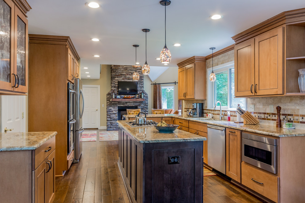 Inspiration for a large galley medium tone wood floor eat-in kitchen remodel in Detroit with an undermount sink, flat-panel cabinets, light wood cabinets, granite countertops, orange backsplash, subway tile backsplash, stainless steel appliances and an island