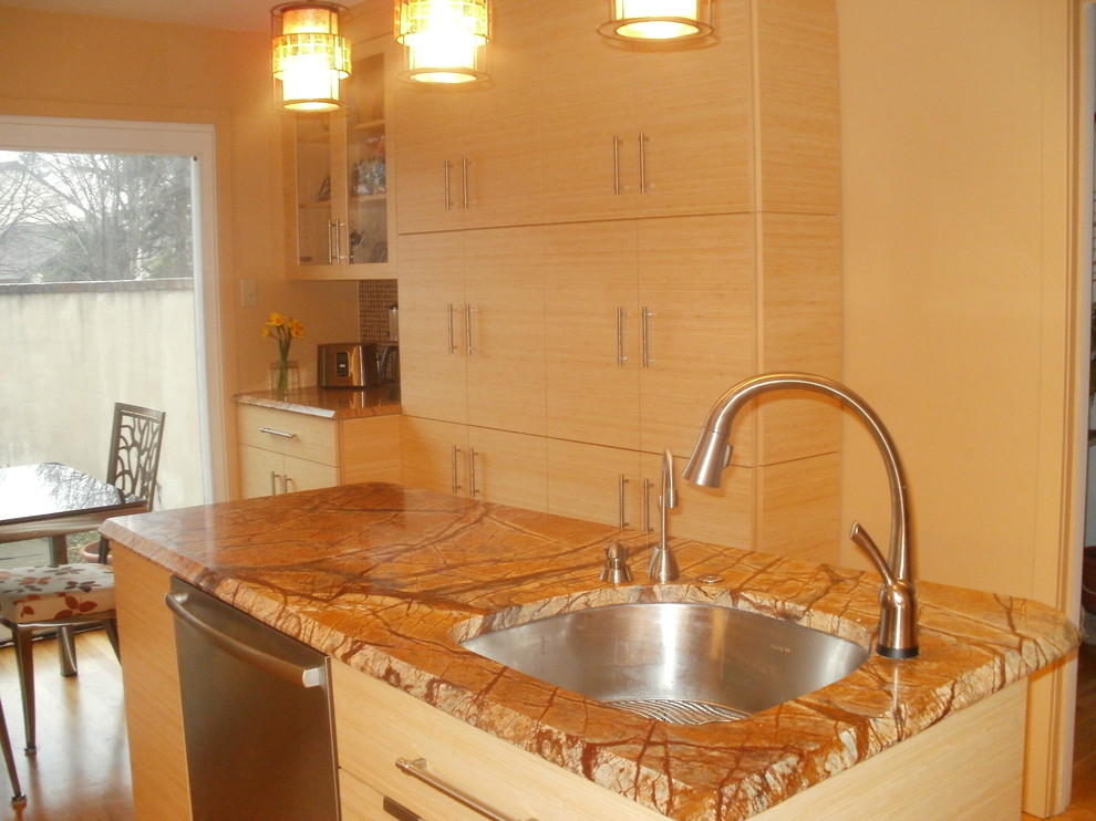 Small trendy l-shaped medium tone wood floor eat-in kitchen photo in Philadelphia with an undermount sink, flat-panel cabinets, light wood cabinets, onyx countertops, multicolored backsplash, mosaic tile backsplash, paneled appliances and an island