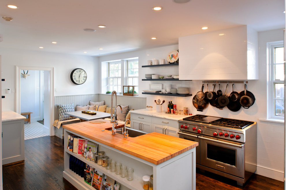 Eat-in kitchen - mid-sized transitional single-wall dark wood floor eat-in kitchen idea in Philadelphia with a farmhouse sink, wood countertops, white backsplash, subway tile backsplash, stainless steel appliances, shaker cabinets, white cabinets and an island