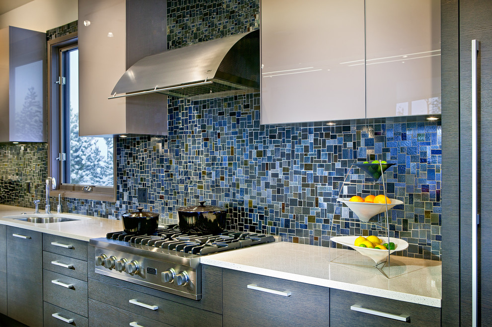 Inspiration for a huge contemporary l-shaped light wood floor and gray floor eat-in kitchen remodel in Atlanta with flat-panel cabinets, gray cabinets, quartz countertops, paneled appliances, an island, an undermount sink, multicolored backsplash and glass tile backsplash