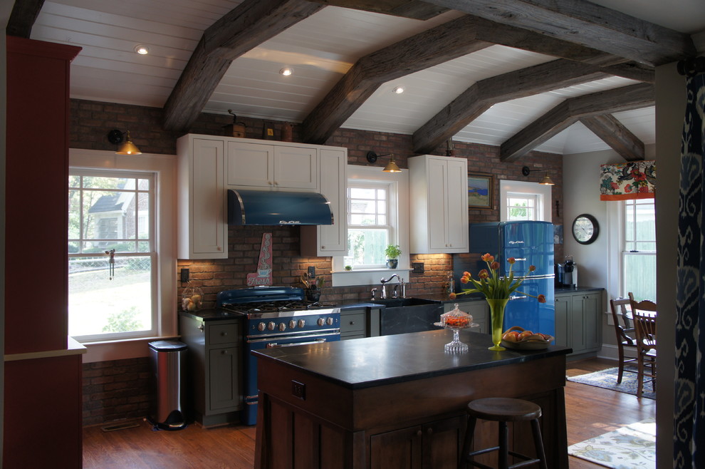 Inspiration for a medium sized farmhouse u-shaped enclosed kitchen in Atlanta with white cabinets, coloured appliances, medium hardwood flooring, an island, a belfast sink, shaker cabinets, soapstone worktops, brick splashback and brown floors.