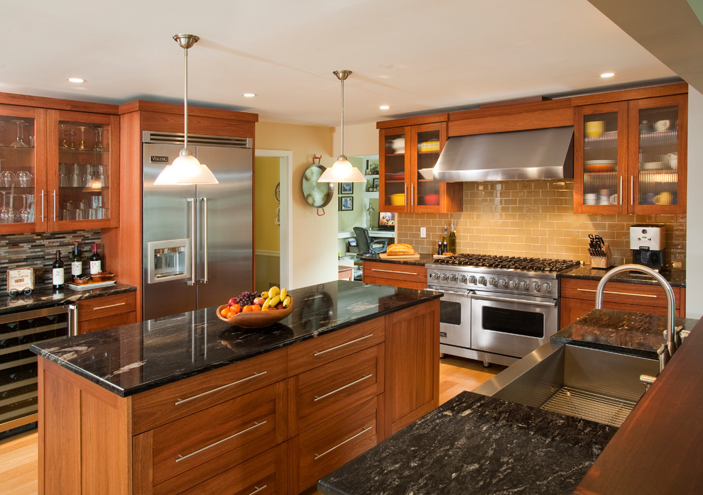 Example of a large classic u-shaped light wood floor eat-in kitchen design in Philadelphia with an integrated sink, shaker cabinets, medium tone wood cabinets, granite countertops, multicolored backsplash, ceramic backsplash, stainless steel appliances and an island