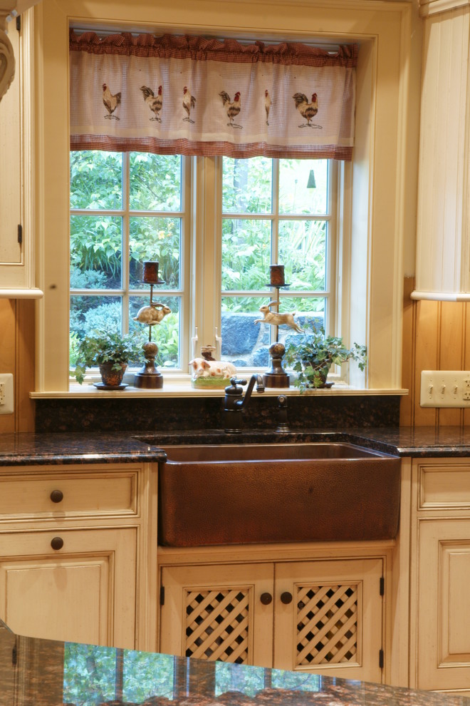 Photo of a medium sized country u-shaped kitchen/diner in Philadelphia with a belfast sink, beaded cabinets, beige cabinets, granite worktops, integrated appliances, a breakfast bar, multi-coloured splashback and medium hardwood flooring.